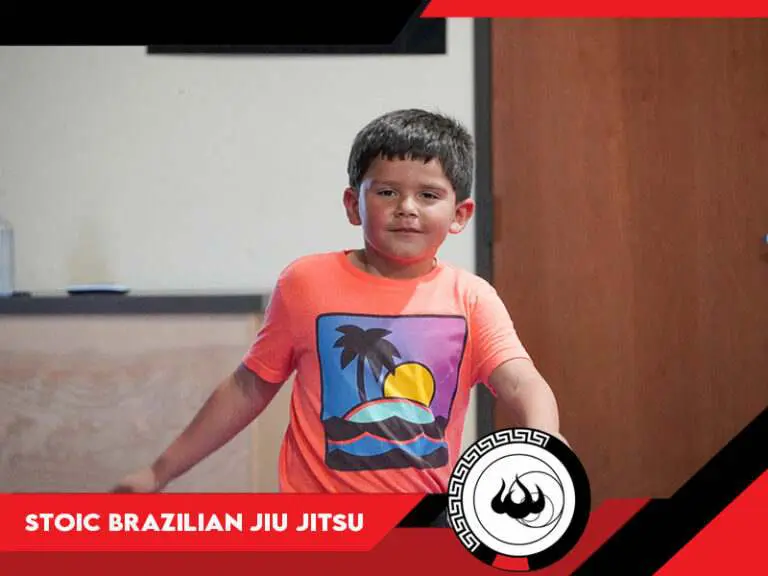 A kids bjj student getting ready for his class at Stoic Brazilian Jiu Jitsu